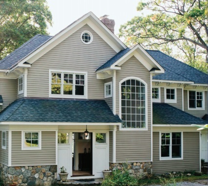 Large two story energy efficient house with many windows and vinyl siding