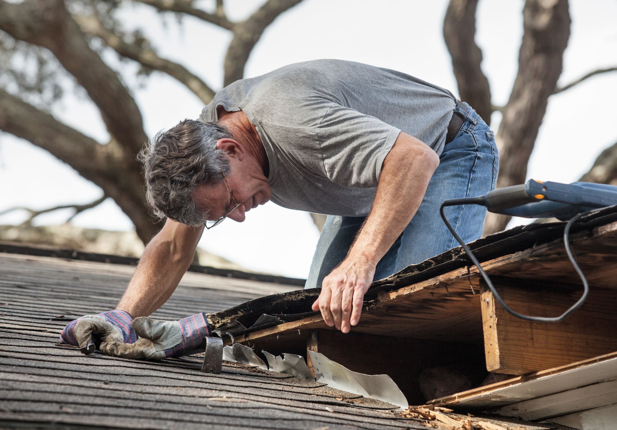 A man looks at his leaking roof