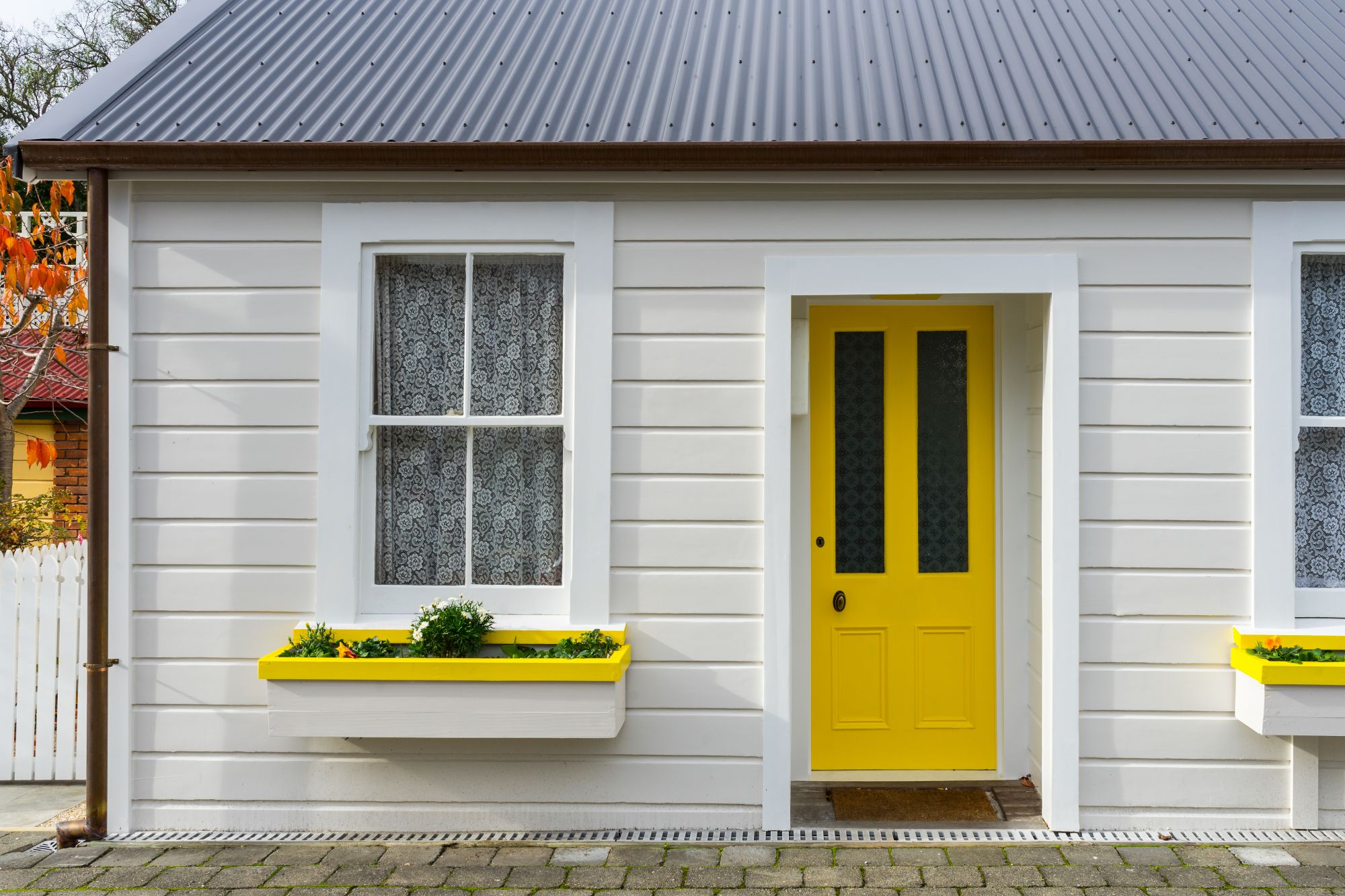 A yellow door brightens up a small home