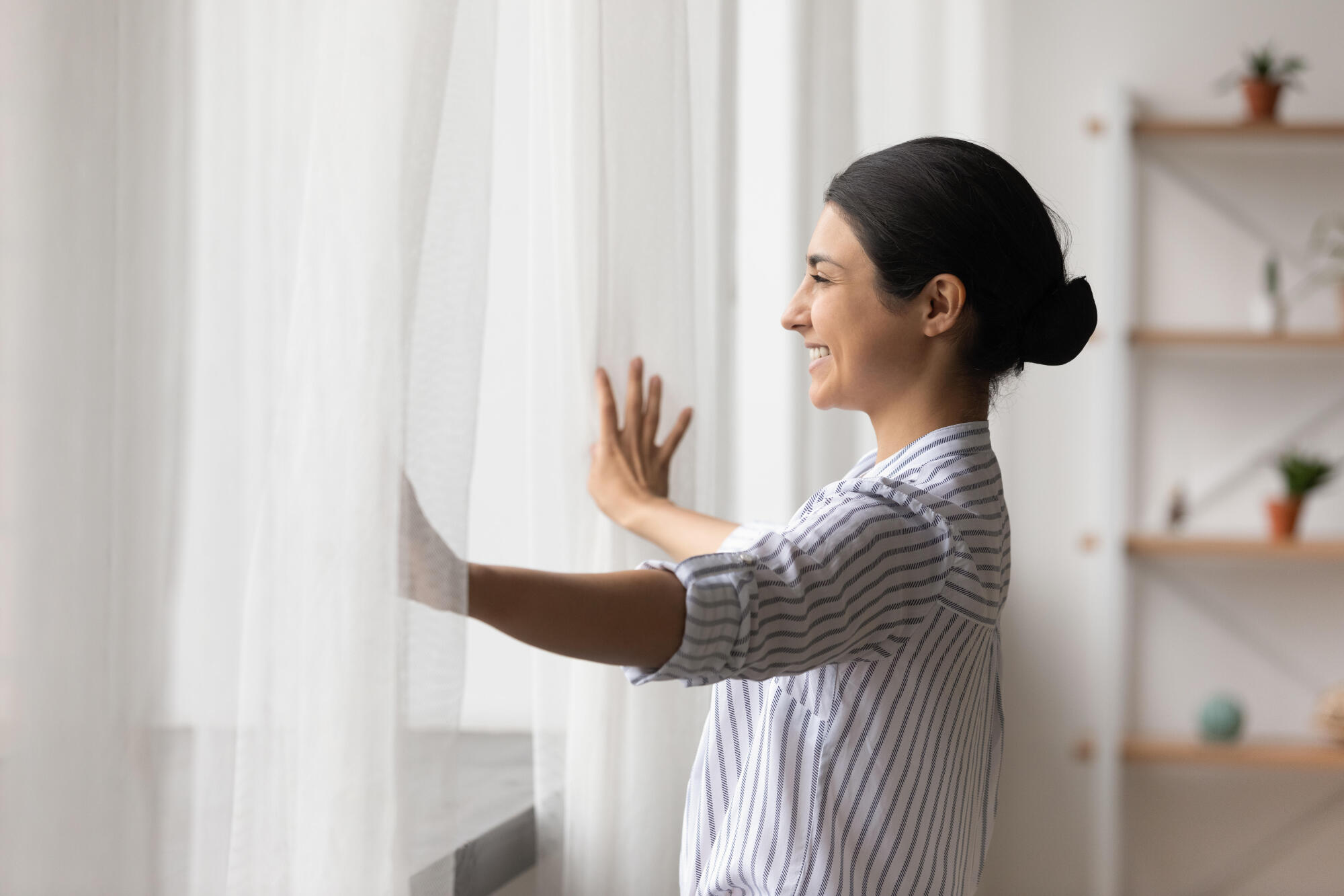 An open, new window lets sunshine into a room