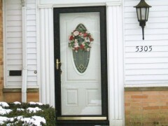 Black frame storm door & glass detail, white front door installation by Fairview Home Improvement in Cleveland, Ohio area