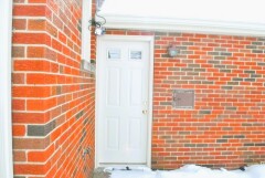 Black frame storm door & glass detail, white front door installation by Fairview Home Improvement in Cleveland, Ohio area