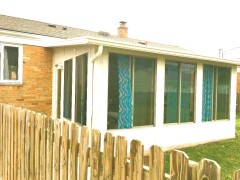 Tan patio enclosure installed by Fairview Home Improvement in Fairview Park, Ohio