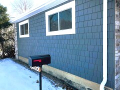 Navy blue siding installed by Fairview Home Improvement in Fairview Park, Ohio