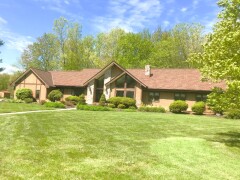 Stone & golden vertical siding installed by Fairview Home Improvement in Avon, Ohio